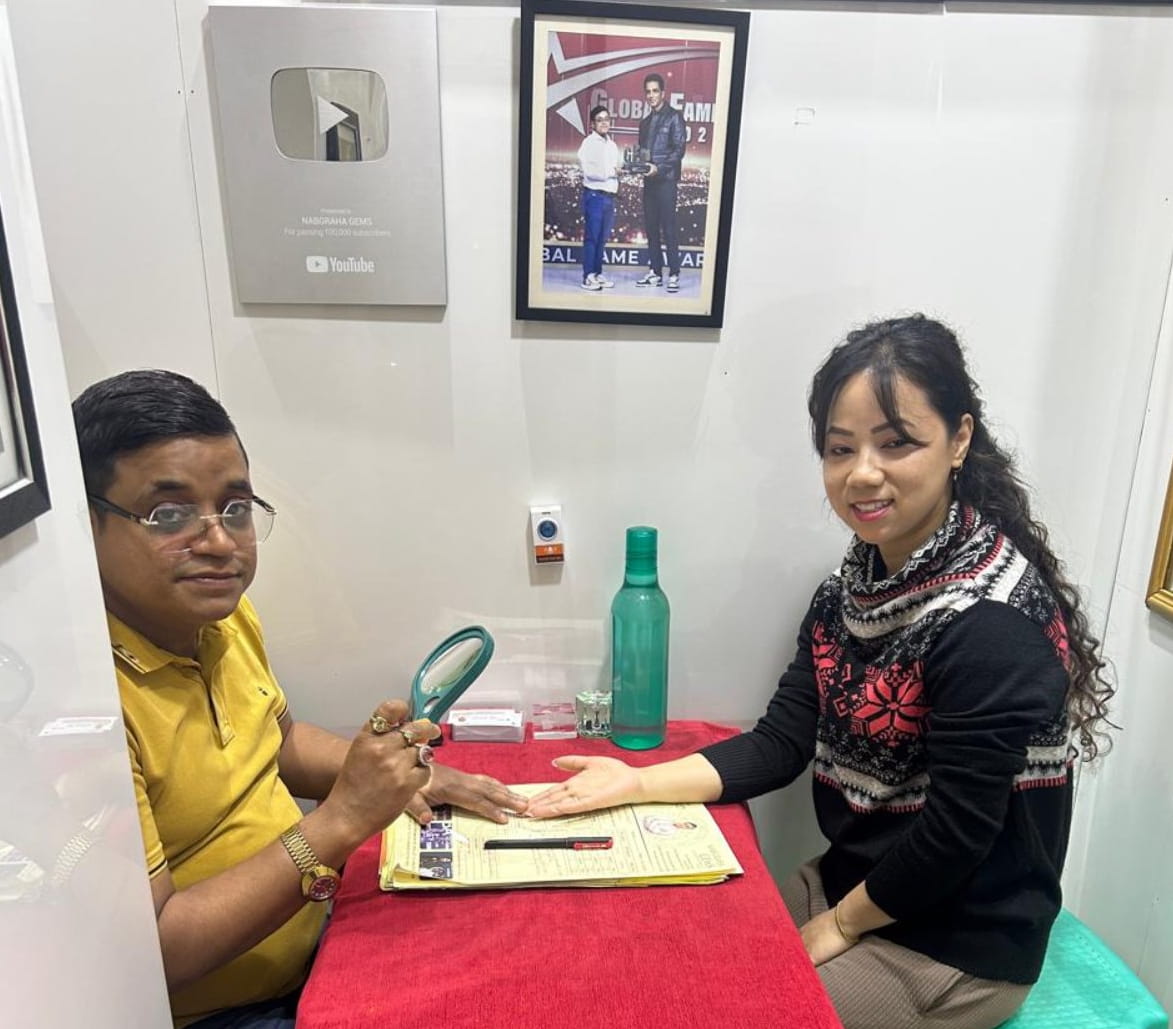A woman consulting Astrologer SK Abid for a palm reading at his Kalighat chamber